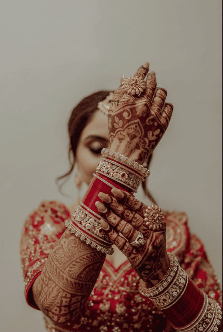 Bridal mehndi hands with bangles close-up
